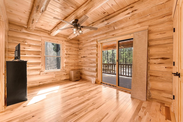 spare room with hardwood / wood-style floors, a wealth of natural light, beam ceiling, and wood ceiling