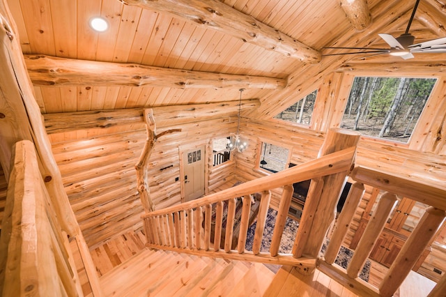 staircase featuring hardwood / wood-style floors, lofted ceiling with beams, log walls, and wood ceiling