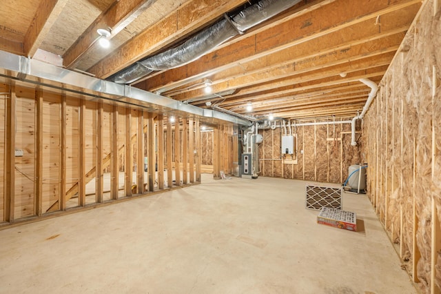 unfinished below grade area featuring tankless water heater