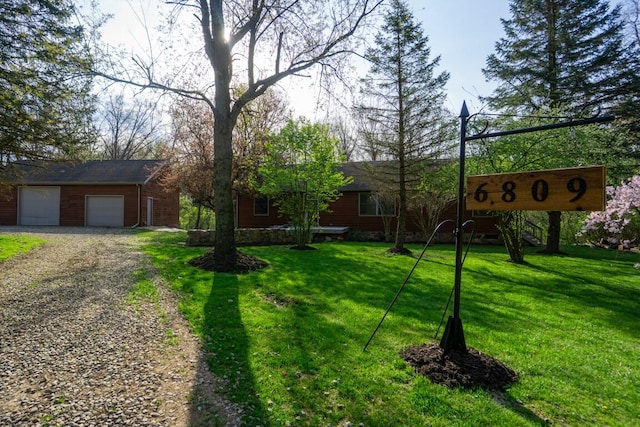 exterior space with a garage and gravel driveway
