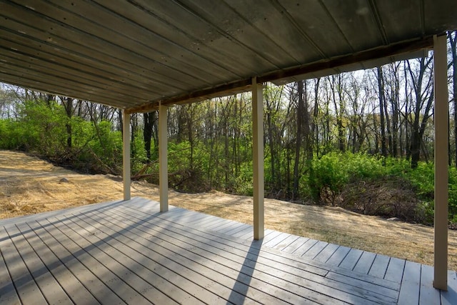 wooden terrace with a view of trees