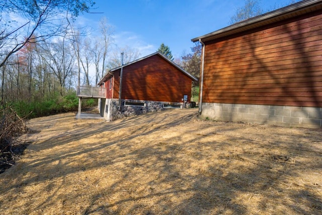 view of side of home with a wooden deck