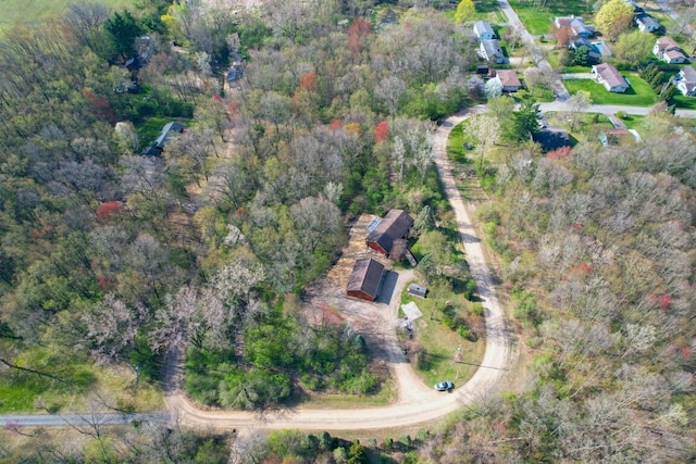 bird's eye view featuring a wooded view