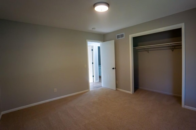 unfurnished bedroom featuring baseboards, visible vents, and carpet flooring