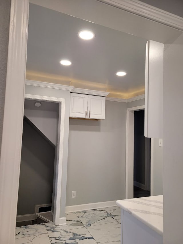 kitchen featuring recessed lighting, ornamental molding, white cabinets, and marble finish floor