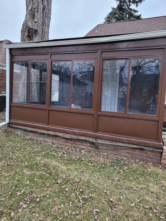 view of property exterior with a sunroom