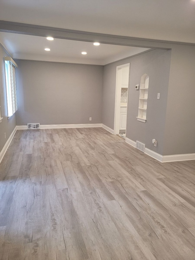 basement featuring recessed lighting, visible vents, wood finished floors, and baseboards