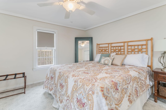 bedroom with crown molding, carpet flooring, and a ceiling fan