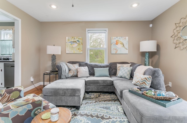living room featuring wood finished floors, recessed lighting, and baseboards