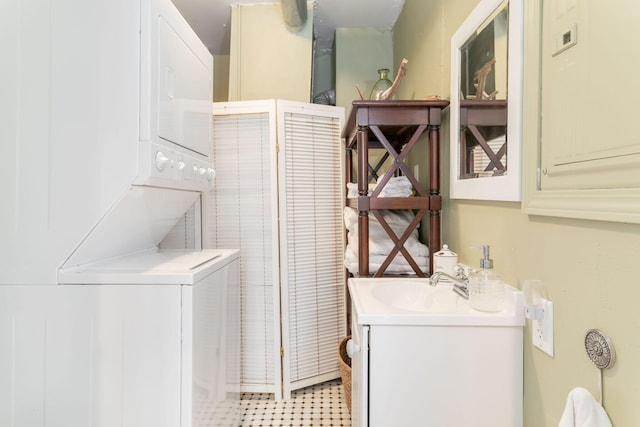 laundry area with a sink, stacked washing maching and dryer, and laundry area