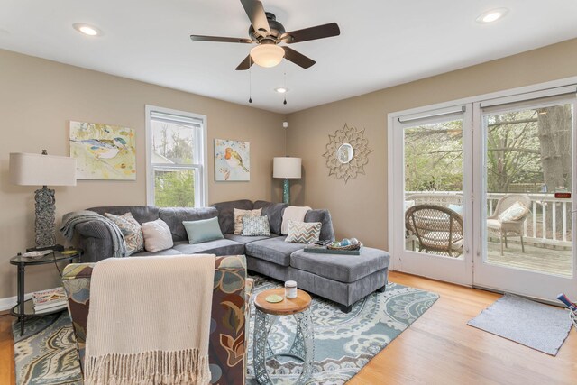living area with recessed lighting, wood finished floors, and a ceiling fan