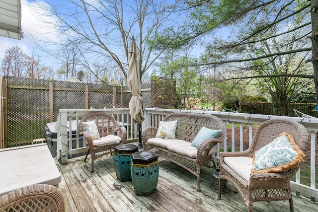 wooden terrace featuring a fenced backyard