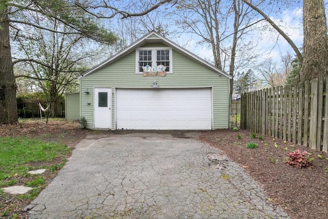 detached garage featuring fence