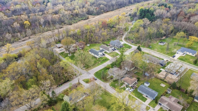 bird's eye view with a wooded view and a residential view