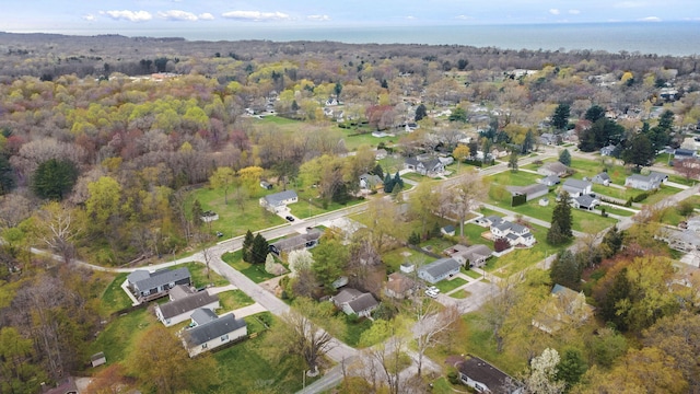 drone / aerial view featuring a residential view and a forest view