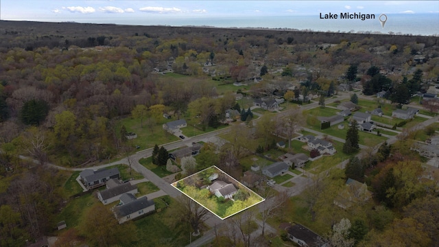 drone / aerial view featuring a residential view and a forest view