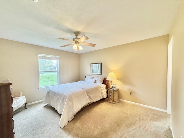 bedroom with a ceiling fan, carpet, and baseboards