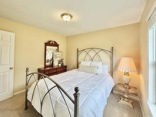 bedroom with baseboards and carpet floors