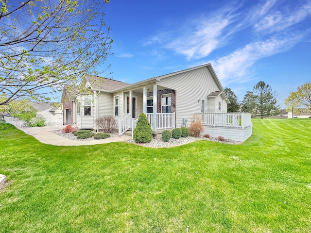 back of house featuring covered porch and a yard
