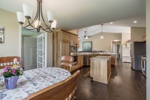 10207 Dodge Rd, Otisville, MI 48463 - kitchen featuring stainless steel appliances, vaulted ceiling, dark wood-style floors, and a peninsula