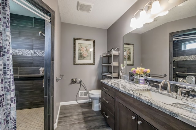 10207 Dodge Rd, Otisville, MI 48463 - full bath with visible vents, wood finished floors, toilet, baseboards, and a tile shower