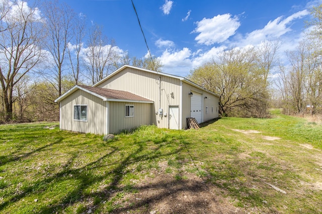 10207 Dodge Rd, Otisville, MI 48463 - view of side of property featuring a yard, an outbuilding, and a garage