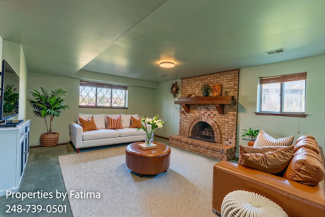 carpeted living area with baseboards, visible vents, a wealth of natural light, and a fireplace