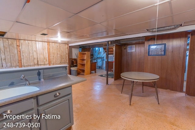 interior space featuring wood walls and a sink