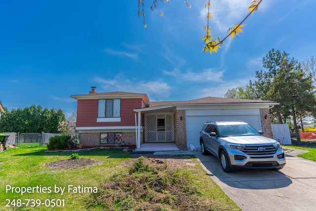 tri-level home featuring fence, concrete driveway, and brick siding