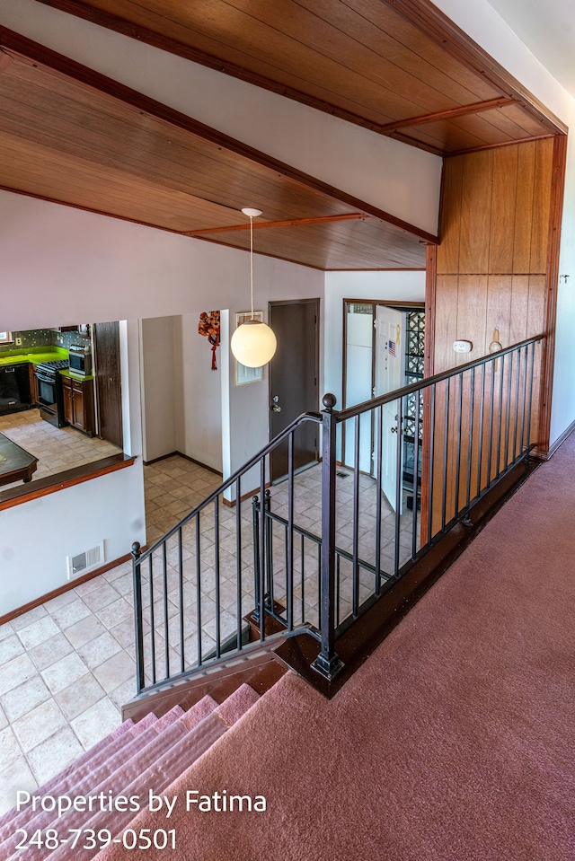 staircase featuring carpet, wood ceiling, lofted ceiling with beams, and visible vents