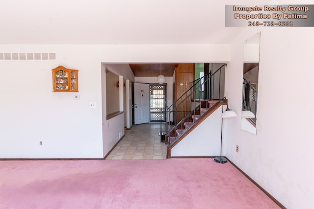 17906 Cider Mill St, Macomb, MI 48044 - entryway featuring carpet, stairway, and baseboards