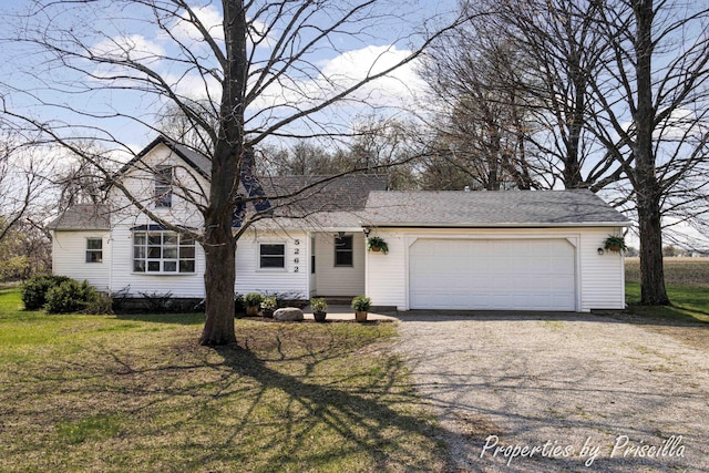 ranch-style home featuring a front yard, driveway, and an attached garage