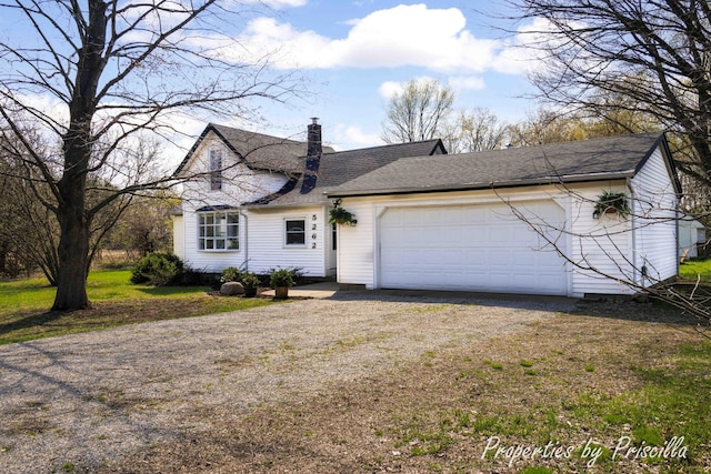 view of front of home with a chimney, a garage, driveway, and roof with shingles