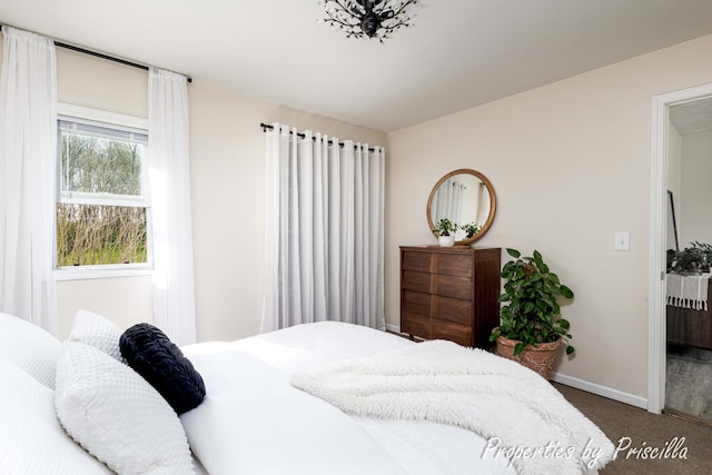 bedroom featuring carpet and baseboards