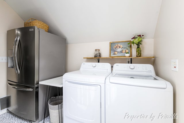 laundry room with visible vents, washer and clothes dryer, and laundry area
