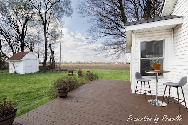 deck with an outbuilding, a shed, and a lawn