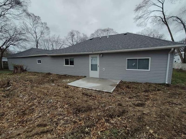 2871 Bailey St, Norton Shores, MI 49444 - rear view of property with a patio and roof with shingles