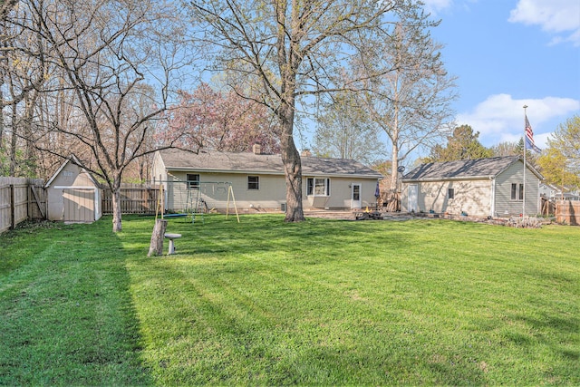 view of yard with an outbuilding, a storage shed, and a fenced backyard