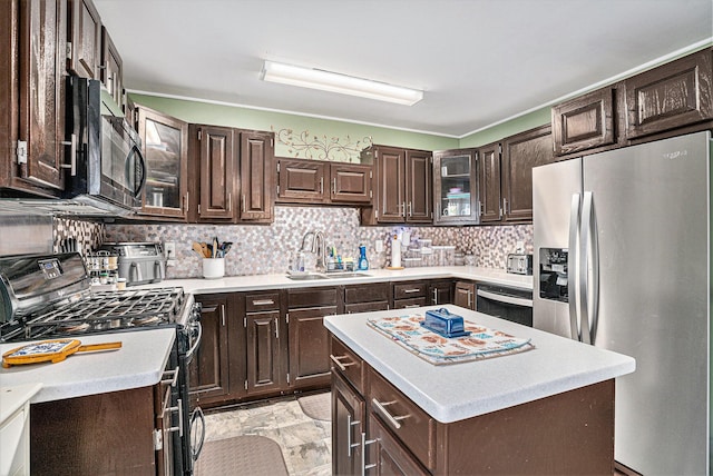 kitchen featuring a sink, gas range, dark brown cabinetry, dishwasher, and stainless steel fridge