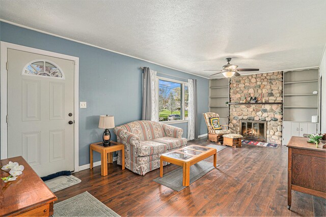 living room featuring a textured ceiling, ceiling fan, and hardwood / wood-style flooring