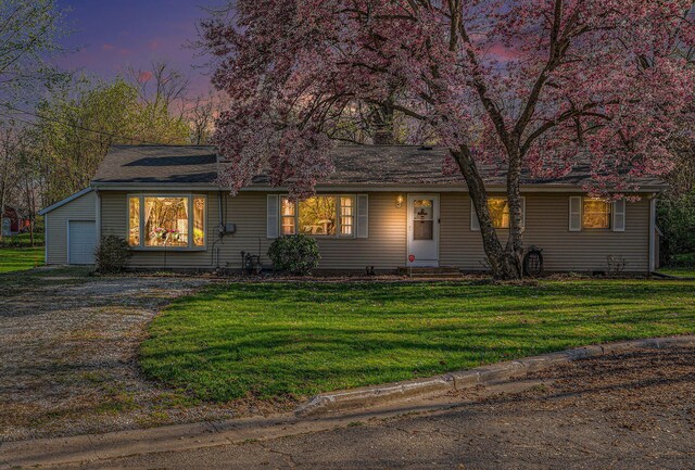 single story home with a yard, dirt driveway, and a garage