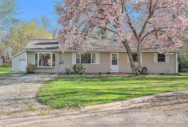 single story home featuring a garage, dirt driveway, entry steps, and a front yard
