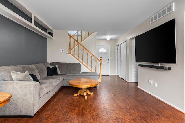 living area featuring stairway, visible vents, wood finished floors, and baseboards