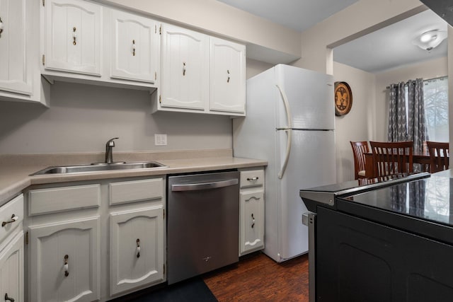 kitchen featuring white cabinetry, dishwasher, freestanding refrigerator, and a sink