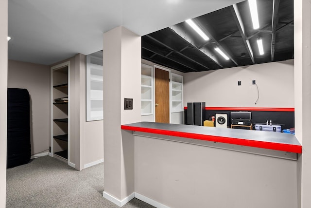 kitchen with baseboards and carpet floors