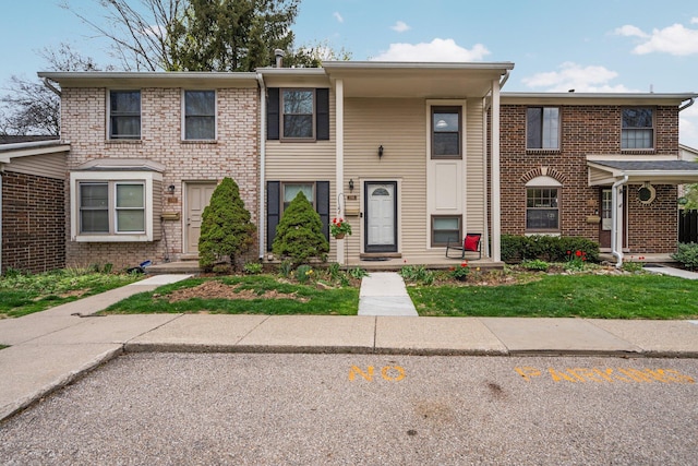 townhome / multi-family property featuring brick siding