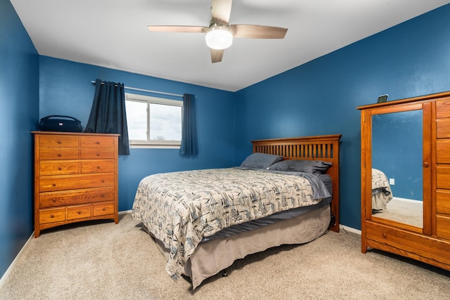 carpeted bedroom with baseboards and a ceiling fan