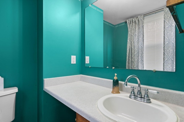 bathroom featuring toilet and vanity