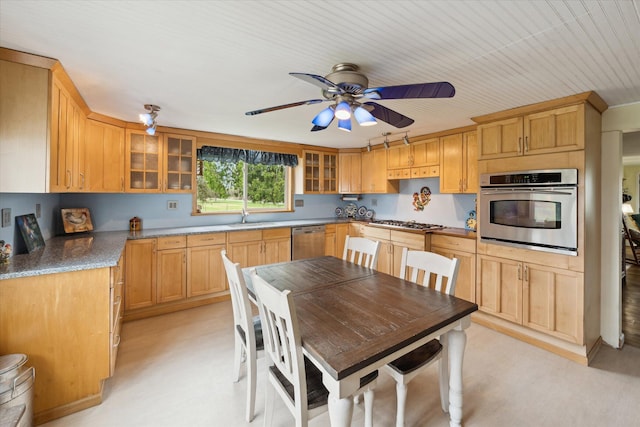 kitchen with light floors, ceiling fan, glass insert cabinets, and appliances with stainless steel finishes
