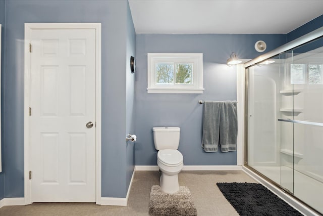 full bath with toilet, a shower stall, and baseboards